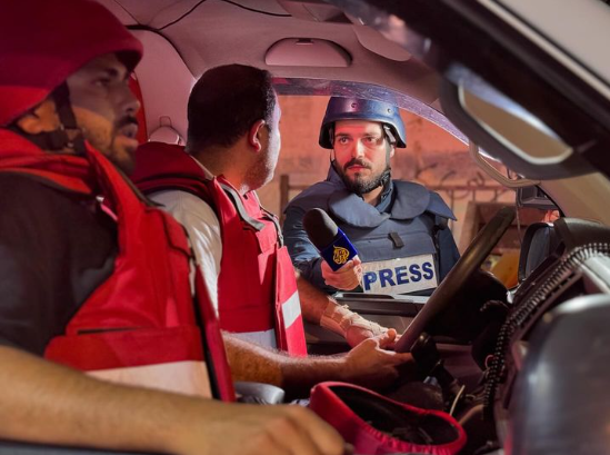 Journalist Mohammed Al-Atrash, interviewing paramedics in their ambulance